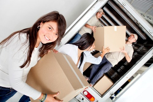 Boxes and furniture being loaded into a moving van